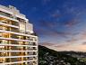 Perspectiva arquitet�nica noturna dos apartamentos do Aman iluminados, com vista para a cidade e a serra 