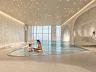 Piscina aquecida coberta com cascata e �rea de sauna no pavimento de lazer wellness