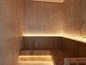 Espa�o interno da sauna destacando as paredes em textura de rocha natural e bancos amadeirados